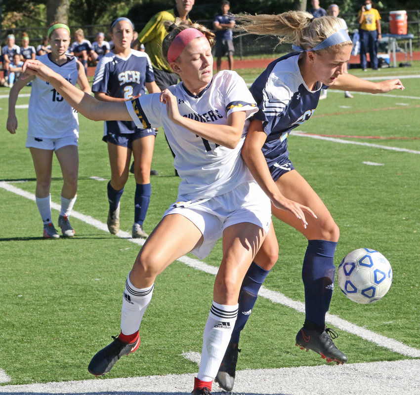 The Blue Devils' Lauren Sullivan (right) tries to maintain possession of the ball as fellow senior Maddie Shoup of Penn Charter cuts in.